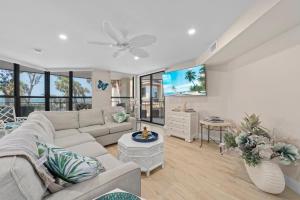 a living room with a couch and a table at Pine Cove 104 in Sanibel