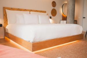 a large bed with a wooden frame in a bedroom at Topá House in Medellín