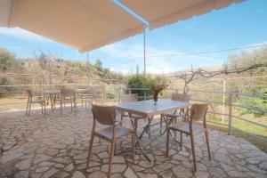 a group of tables and chairs on a patio at Rusha Family in Qeparo