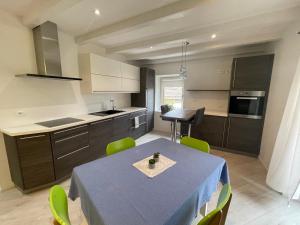 a kitchen and dining room with a table and chairs at Casa Tilì in Ziano di Fiemme