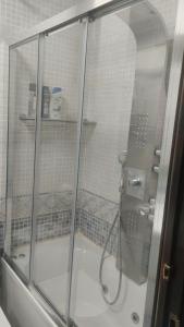 a shower with a glass enclosure in a bathroom at Habitaciones individuales en apartamento in Madrid +38 photos