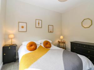 a bedroom with a bed with two pumpkins on it at 49 Castlegate in Jedburgh