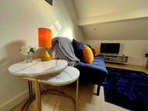 a living room with a blue couch and a table at McCartney Place at the Cavern Quarter in Liverpool