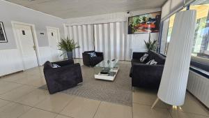 a living room with two couches and a coffee table at Hotel Miramar Playa America Nigran in Nigrán