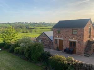 an aerial view of a brick house with a yard at The Woottons Barn with Hot Tub in Croxden