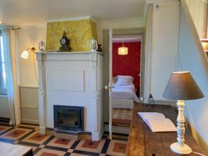 a living room with a fireplace and a bedroom at La Maison de la Rose in Étretat +66 photos