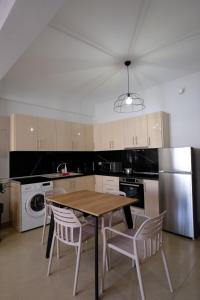 a kitchen with a wooden table and chairs in it at Eva House 2 in Drama