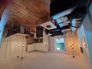 a living room with a vaulted ceiling with shoes hanging from it at Ferienhaus Petri Heil in Oberlangen