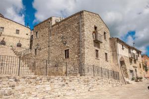 a large stone building with a fence in front at Asteria Guest&Artist House - Casa Tersìcore in Roseto Valfortore