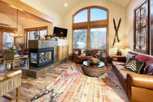 a living room with a couch and a fireplace at Terraces 602 by Exceptional Stays in Telluride