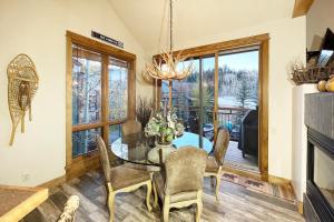 a dining room with a glass table and chairs at Terraces 602 by Exceptional Stays in Telluride