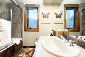 a bathroom with a sink and a toilet and windows at Terraces 602 by Exceptional Stays in Telluride +15 photos