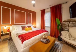 a bedroom with a bed and a chair in a room at King Suite | North Shore | Gigabit Internet in Chattanooga