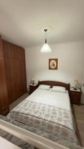 a bedroom with a large bed with two pillows at K&M apartment in Polisi i Vogël