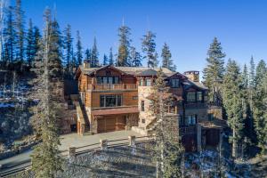 a large wooden house in the middle of a forest at Two Trails by Exceptional Stays in Telluride