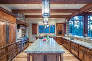 a large kitchen with wooden cabinets and a large island at Two Trails by Exceptional Stays in Telluride