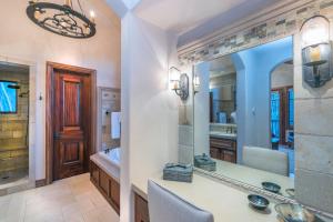 a bathroom with a sink and a large mirror at Two Trails by Exceptional Stays in Telluride +28 photos