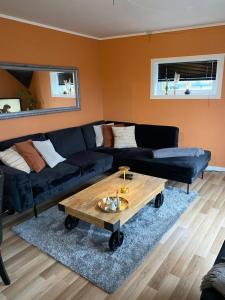 a living room with a couch and a coffee table at Leilighet med sydvendt balkong in Ålesund