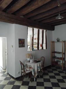 a dining room with a table and chairs at La Tour Des Douves in Saint-Firmin-sur-Loire