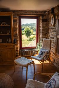 a living room with a chair and a window at Lodge de La Vallée in Saint-Rémy