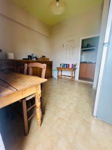 a dining room with a wooden table and chairs at Agiazi Vacation Rooms Pitsidia in Pitsidia +25 photos