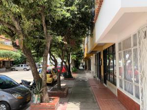 a sidewalk in front of a building with cars parked at Habitación Independiente y baño privado - RURAL in Girón