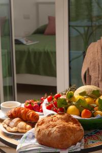 a table topped with plates of food and fruit at Dimora Nesea in Cozze
