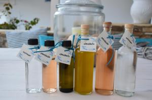 a group of bottles of oils sitting on a table at ThalaSEA - village Antiparos in Antiparos