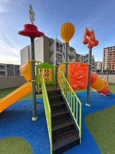 a playground with a slide and slides at Comfortable 2 bedroom apartment with pool in Miramar in Barranquilla