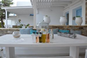 a white table with bottles on top of it at ThalaSEA - village Antiparos in Antiparos