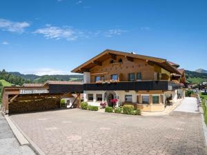 a large house with a driveway in front of it at Apartment Daniela-2 by Interhome in Niederau