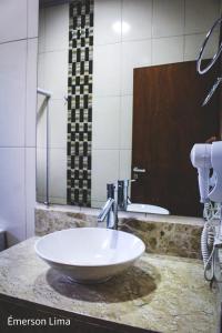 a bathroom counter with a sink and a mirror at Casa do Pico in Santo Antônio do Pinhal