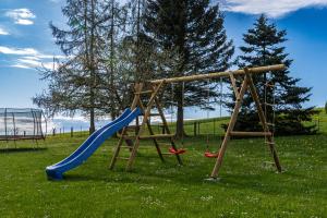 a playground with a blue slide and a slide at Familienapartment Vogtland in Saalig
