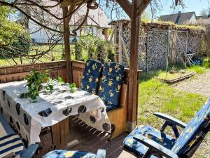 a table and chairs sitting under a gazebo at Holiday Home Hammel by Interhome in Ostseebad Koserow