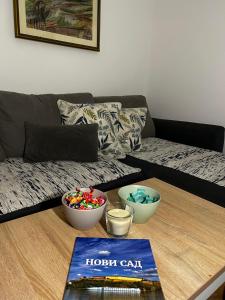 a living room with a couch and a table with bowls of candy at Vila Fruškogorski Mir in Velika Remeta