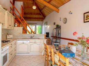 a kitchen with white cabinets and a table at Holiday Home La Mouette Rieuse by Interhome in La Bernerie-en-Retz