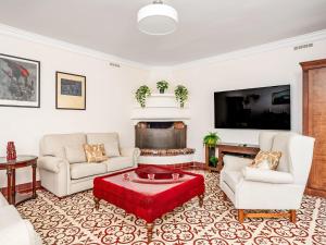 a living room with white furniture and a fireplace at Holiday Home El patio de Lazaro by Interhome in Fuengirola +31 photos