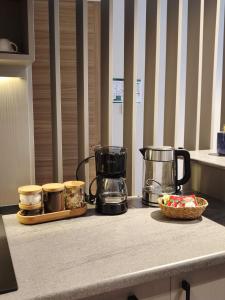 a counter with two coffee makers and a basket of food at La Casa Privada in Istanbul +128 photos