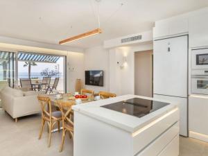 a kitchen and living room with a table and chairs at Apartment Marinada Cambrils by Interhome in Cambrils