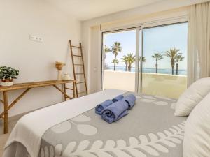 a bedroom with a bed with a view of the ocean at Apartment Marinada Cambrils by Interhome in Cambrils
