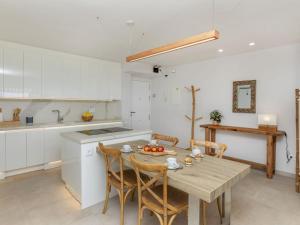 a kitchen with a table and chairs in a kitchen at Apartment Marinada Cambrils by Interhome in Cambrils +16 photos