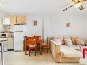 a kitchen and living room with a couch and a table at Apartment Residencia del Mar II by Interhome in Puerto de Mazarrón