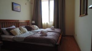 a bedroom with a bed with a teddy bear on it at Garden of Eden in Sveti Vlas