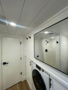a white laundry room with a washer and dryer at Tiny Home Getaway in Bella Vista