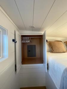 a bedroom with a bed and a tv in a room at Tiny Home Getaway in Bella Vista