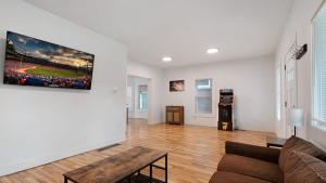 a living room with a couch and a table at Beautiful 4 bedroom home short walk to Niagara Falls in Niagara Falls