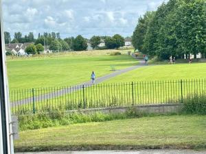 a person walking down a path in a park at Urban Garden Hideaway in Dublin +19 photos