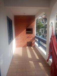 a room with a brick wall and a fireplace at Pousada Del Mare in Florianópolis