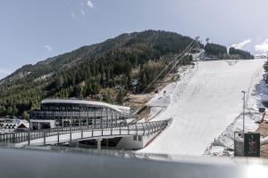 a ski resort with a ski slope and a ski lift at Appartements Aurikel Corso in Ischgl