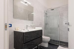 a bathroom with a toilet and a sink and a shower at ALG Apartments con Parcheggio in Porto Cesareo